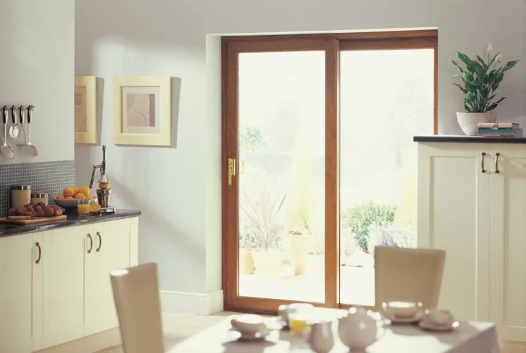 Golden-oak effect uPVC sliding patio door in a cream kitchen diner